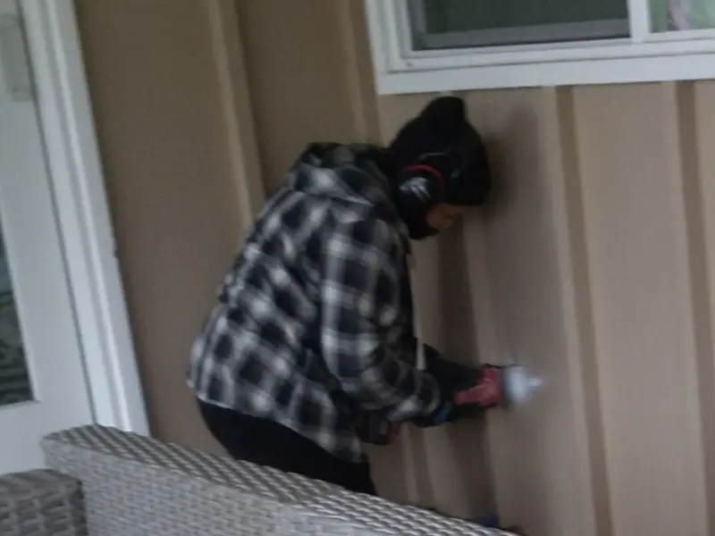 Professional electrician installing an exterior outlet in Warrensburg